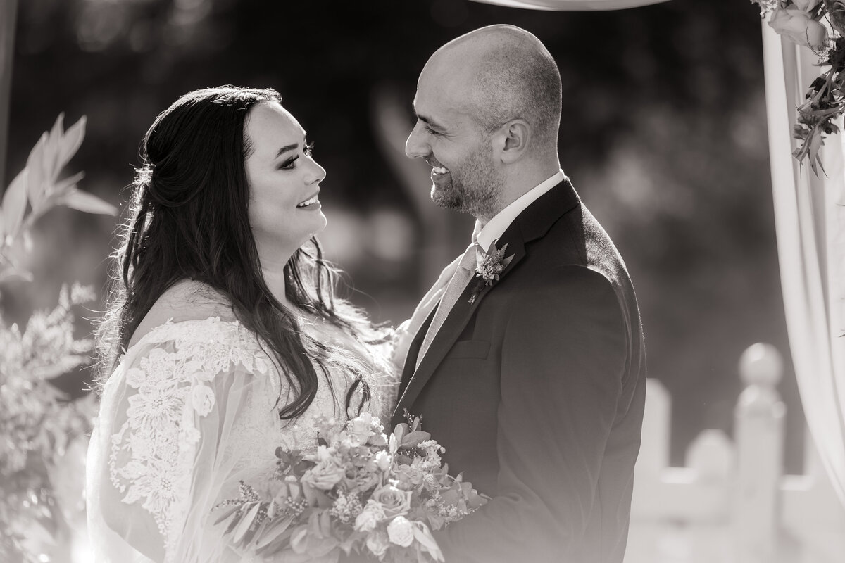 Bride and groom stare lovingly at each other 