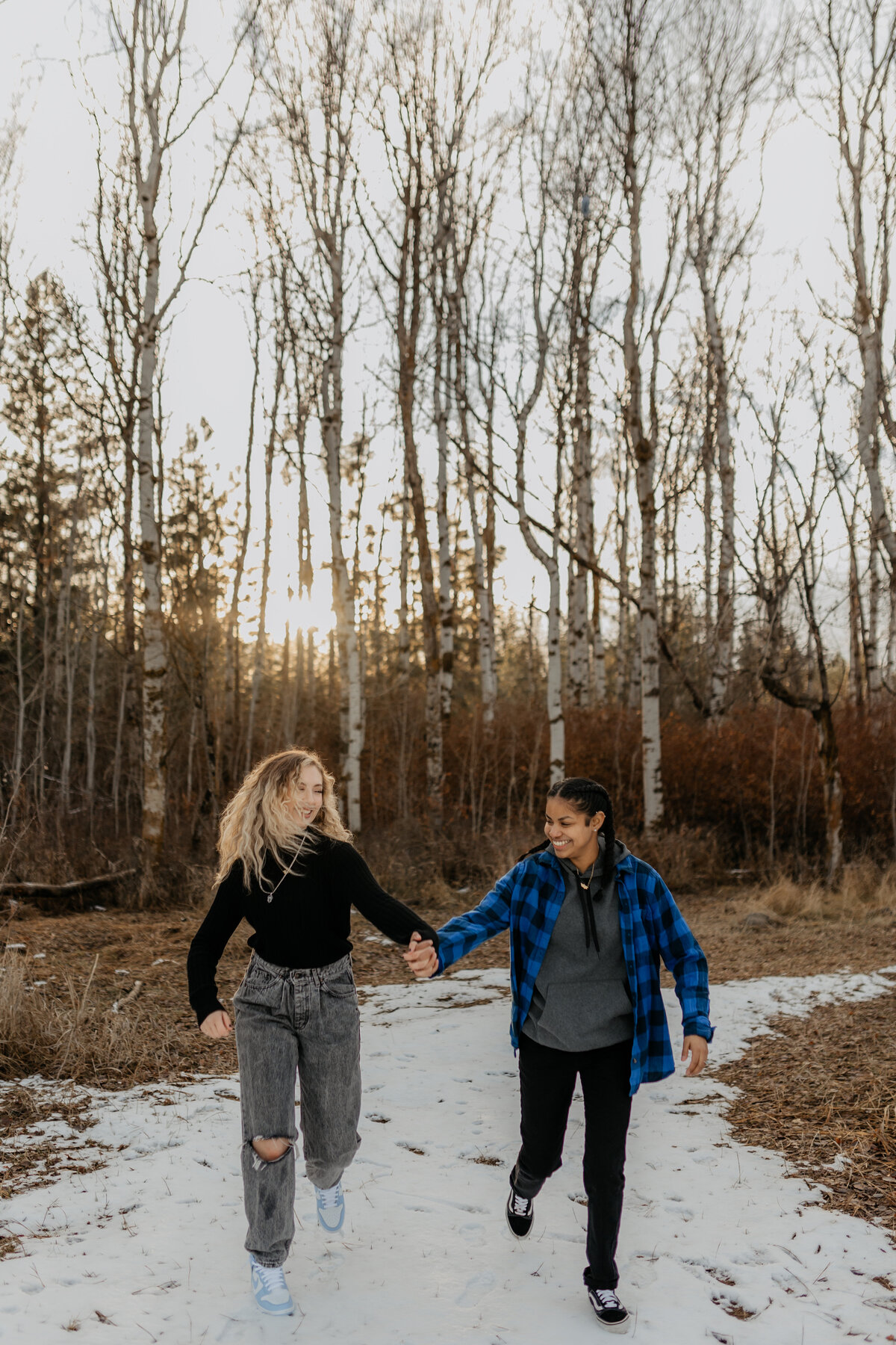 surprise snow session with couple running in forest