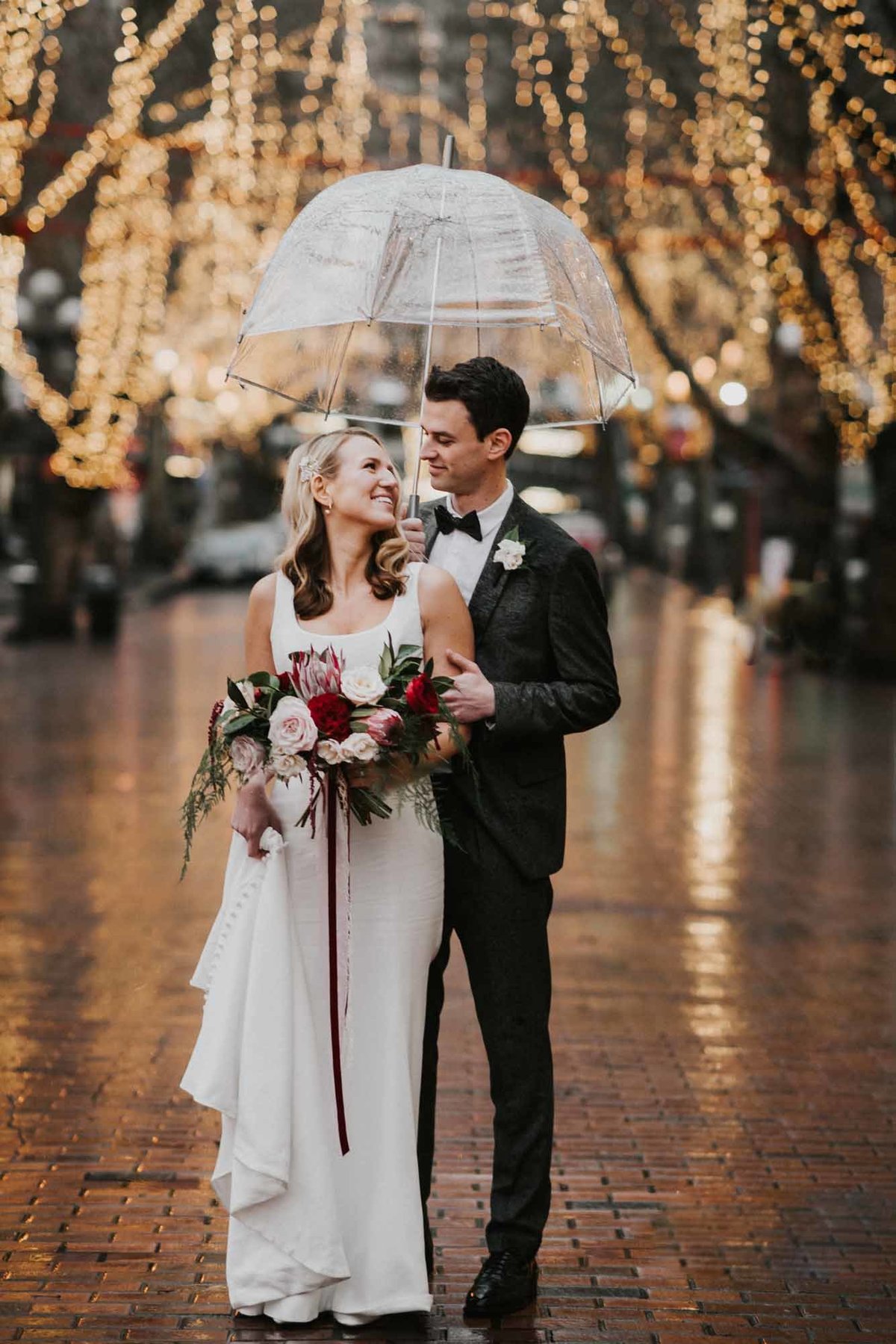 Bride and groom in Pioneer Square Seattle in the rain with clear umbrella