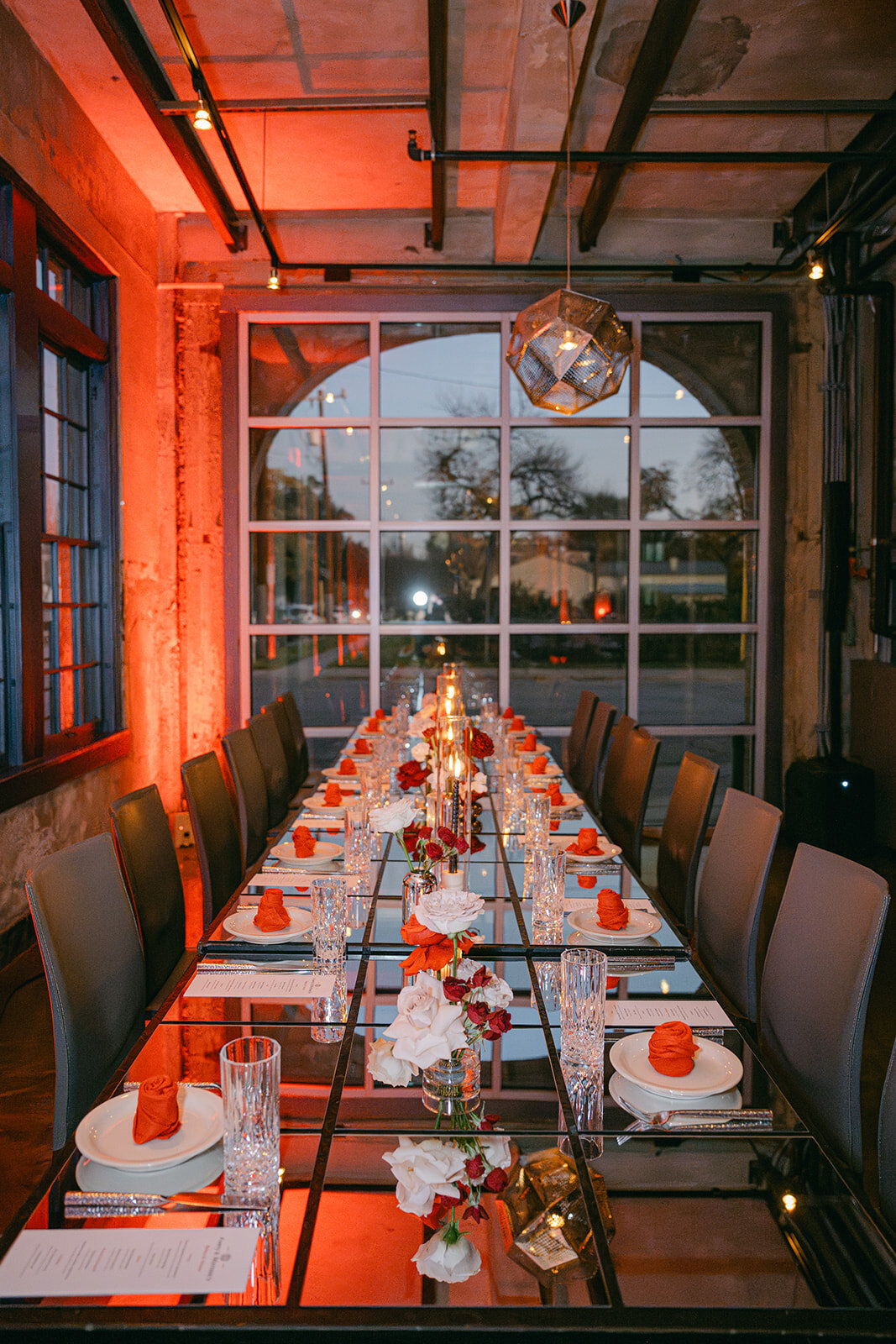 Glass and mirror tablescape reflecting ambient lighting and tall candles in historic San Antonio venue