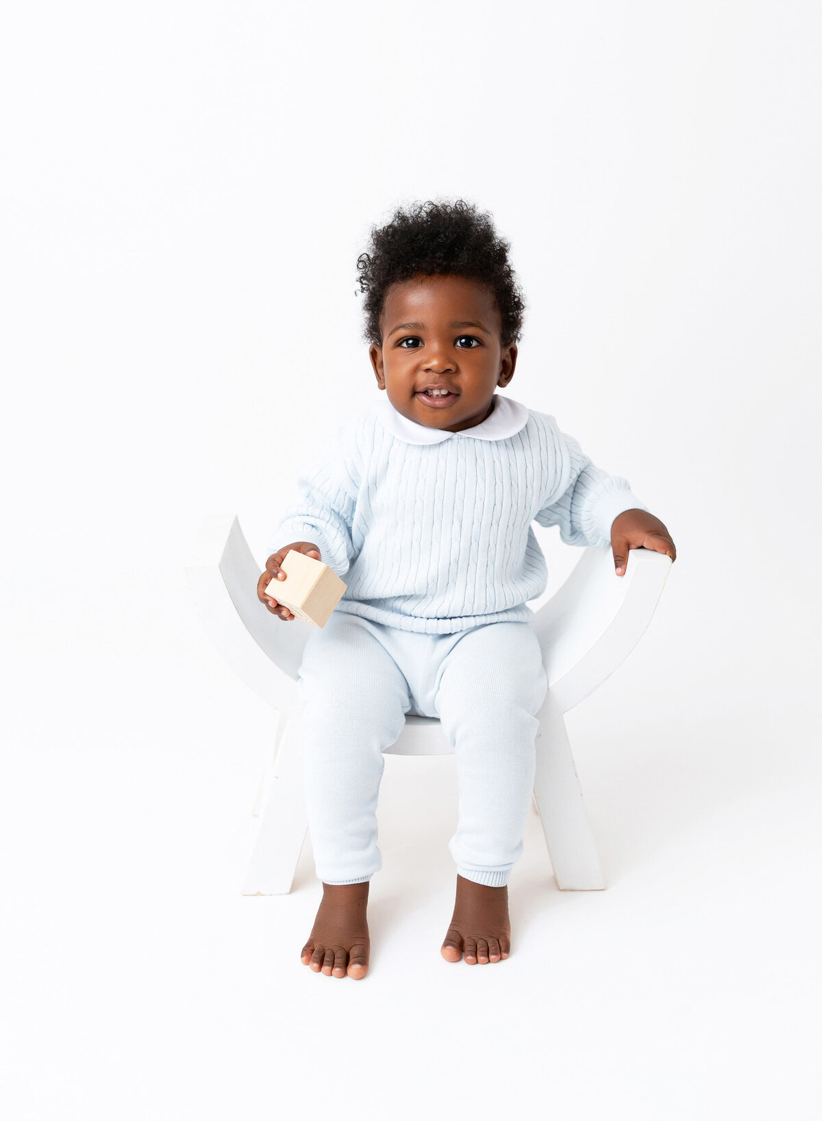 Modern baby photography NYC baby boy sitting on the chair 