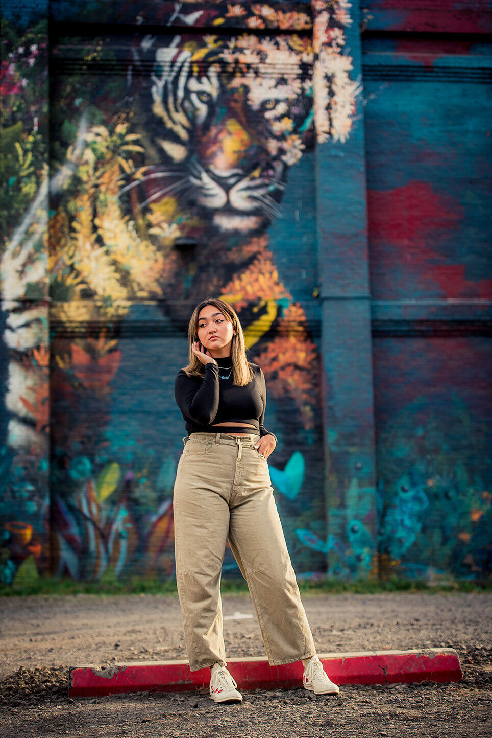 girl in front of mural