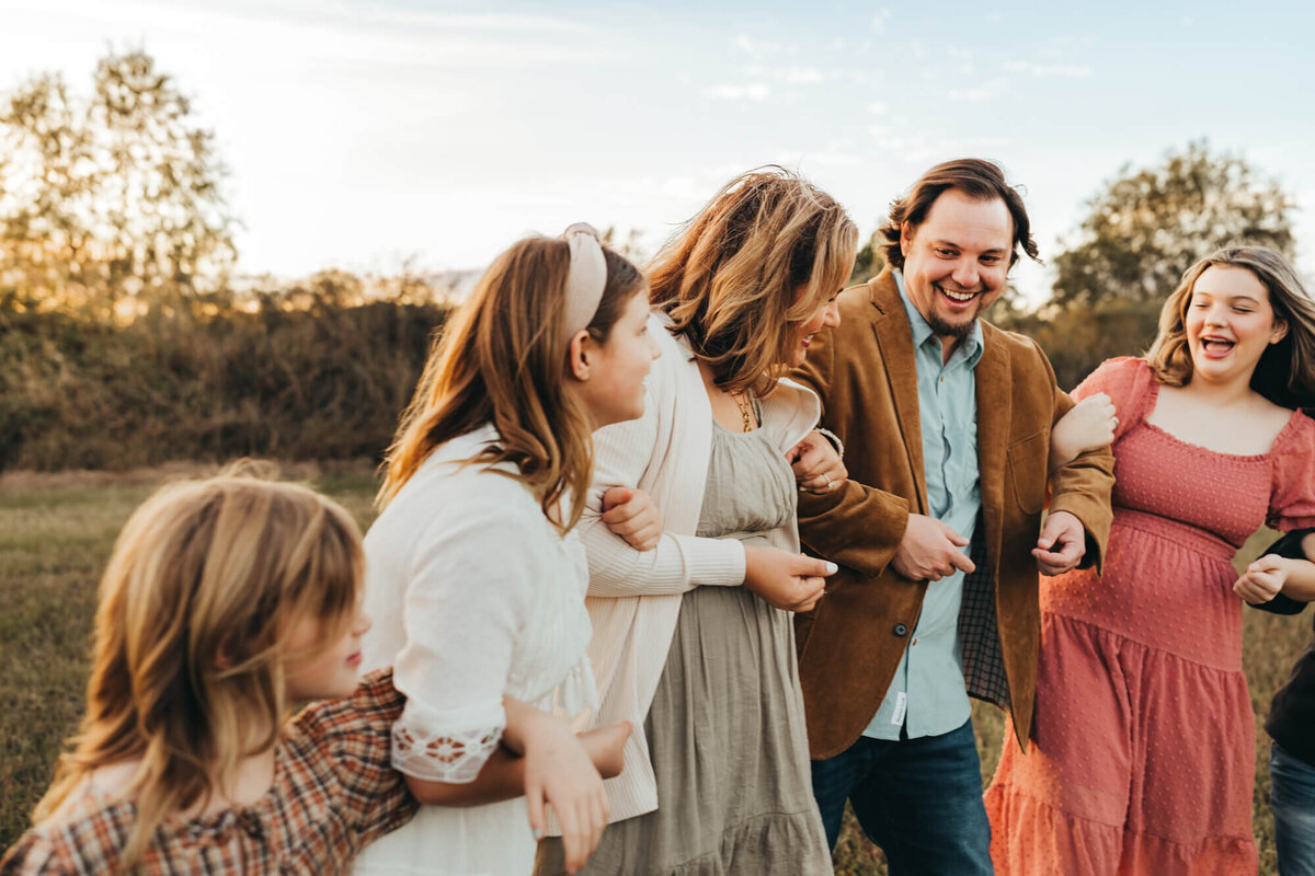 family sways back and forth with arms locked in Houston, Texas.