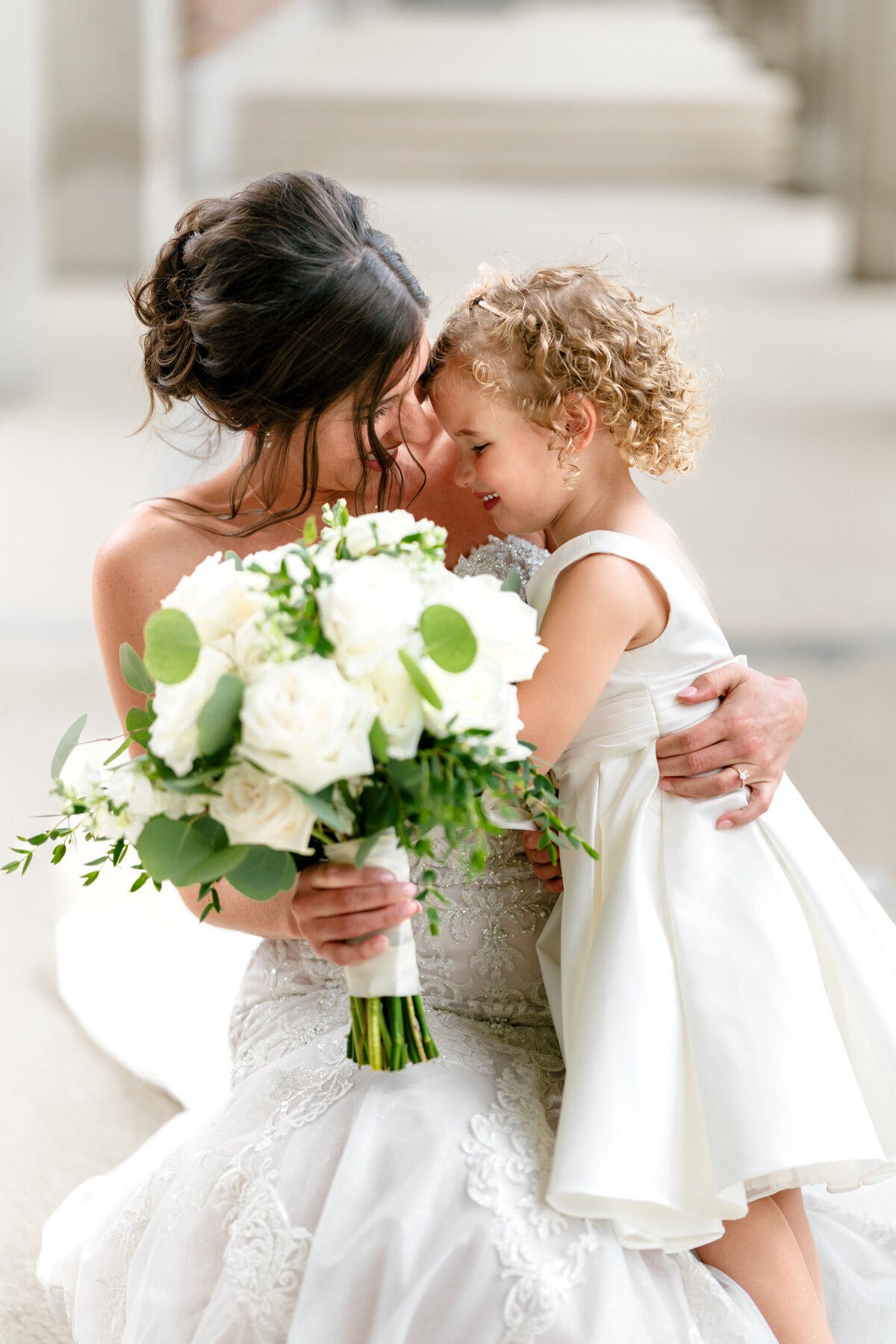 Aspen-Avenue-Chicago-Wedding-Photographer-Classy-Modern-Grand-Joliet-Mansion-Flower-Girl-Bride-Hugging-Candid