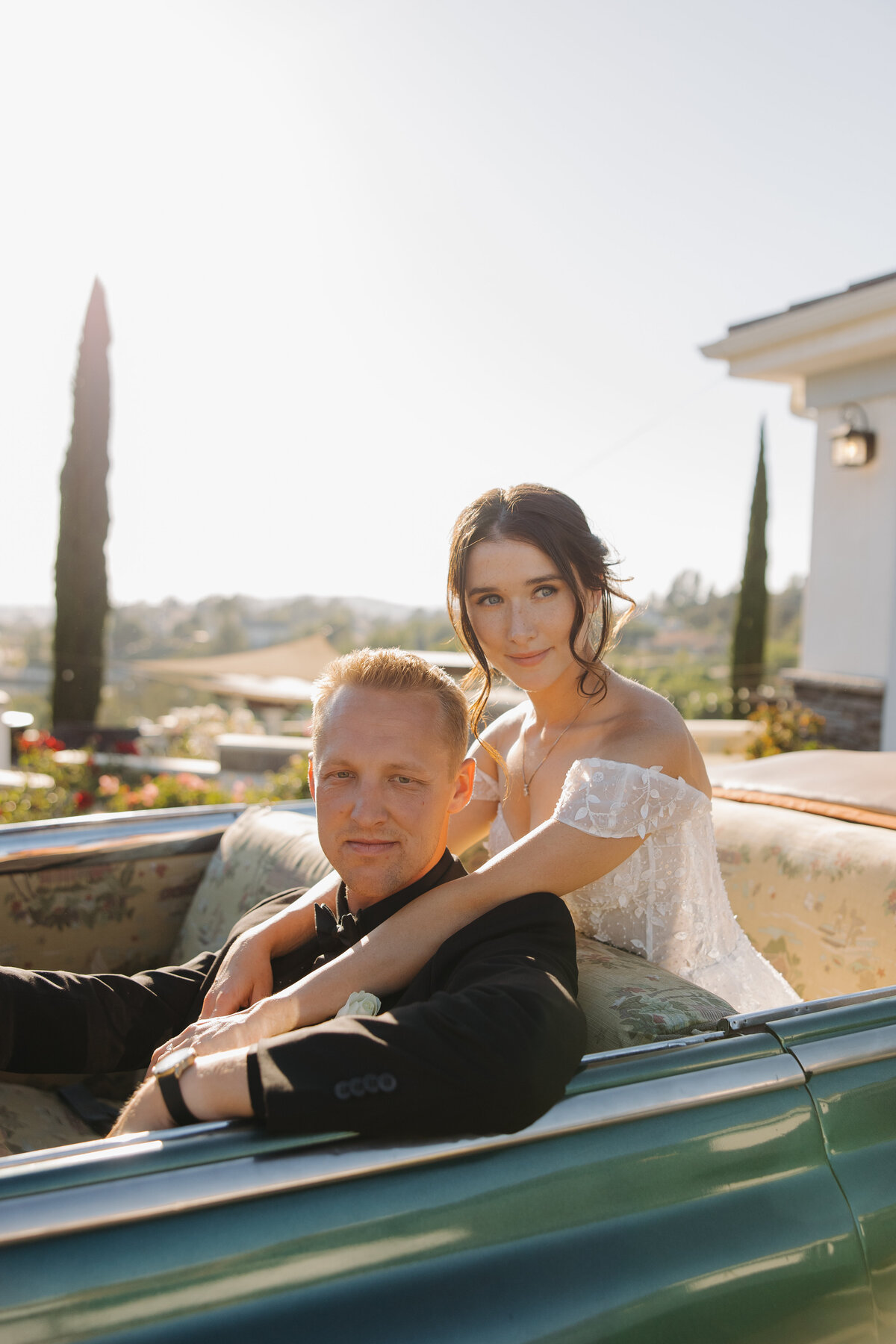 bride and groom sitting in car