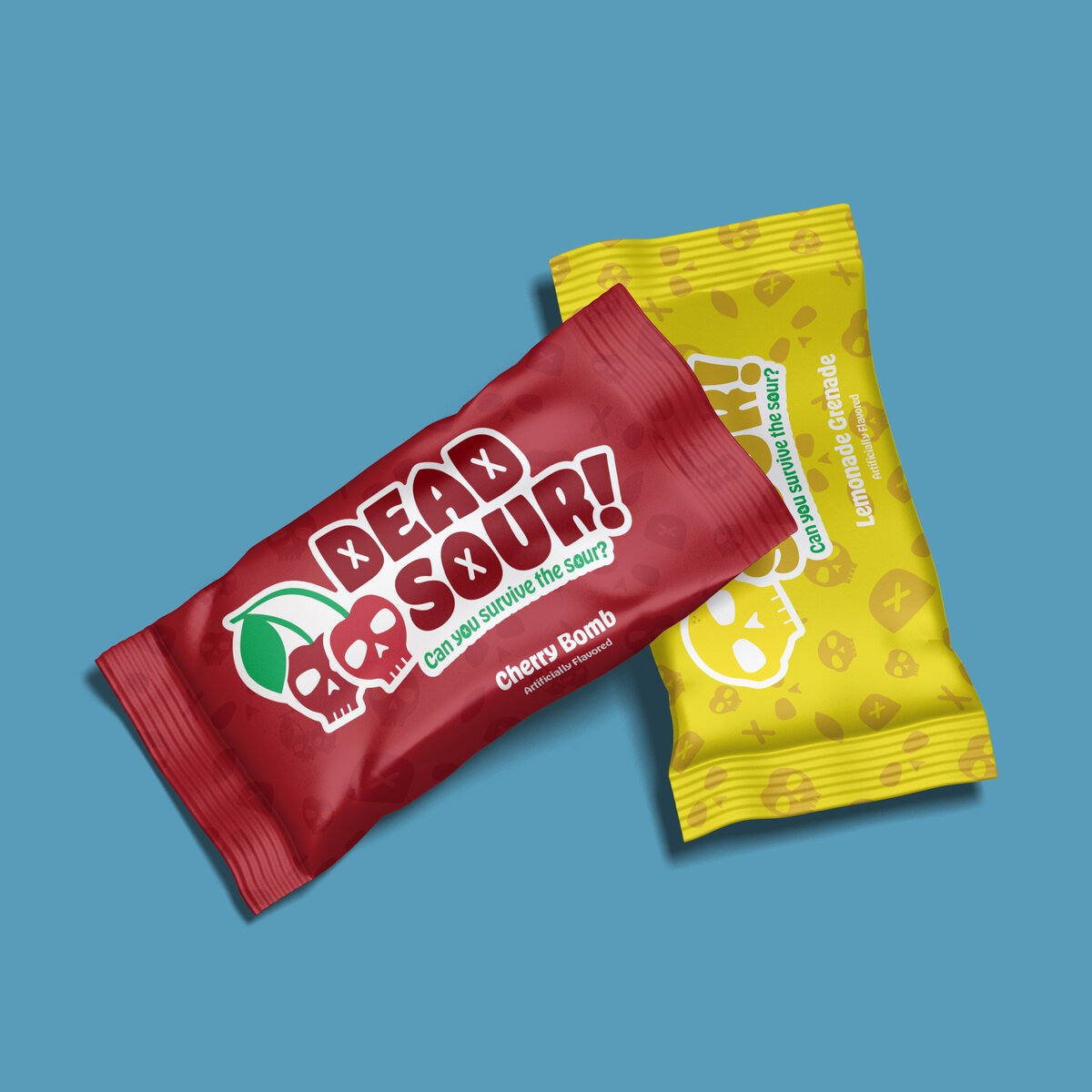 Two Dead Sour candies one on top of the other in the flavors cherry bomb and lemonade grenade on a blue background
