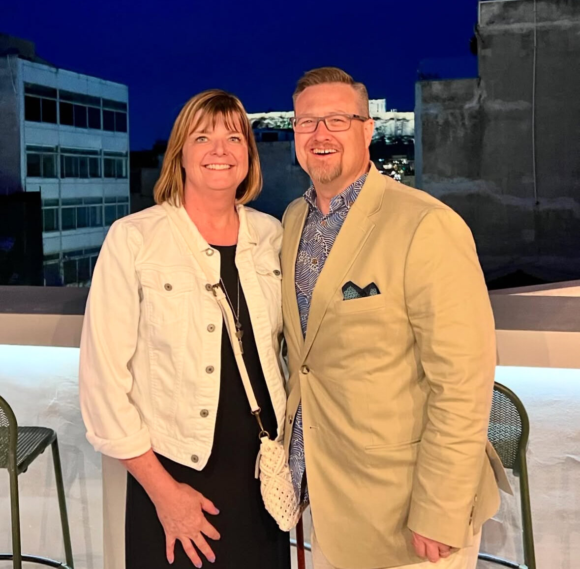 Kelly and Jason Smiling at a Formal Event in Greece