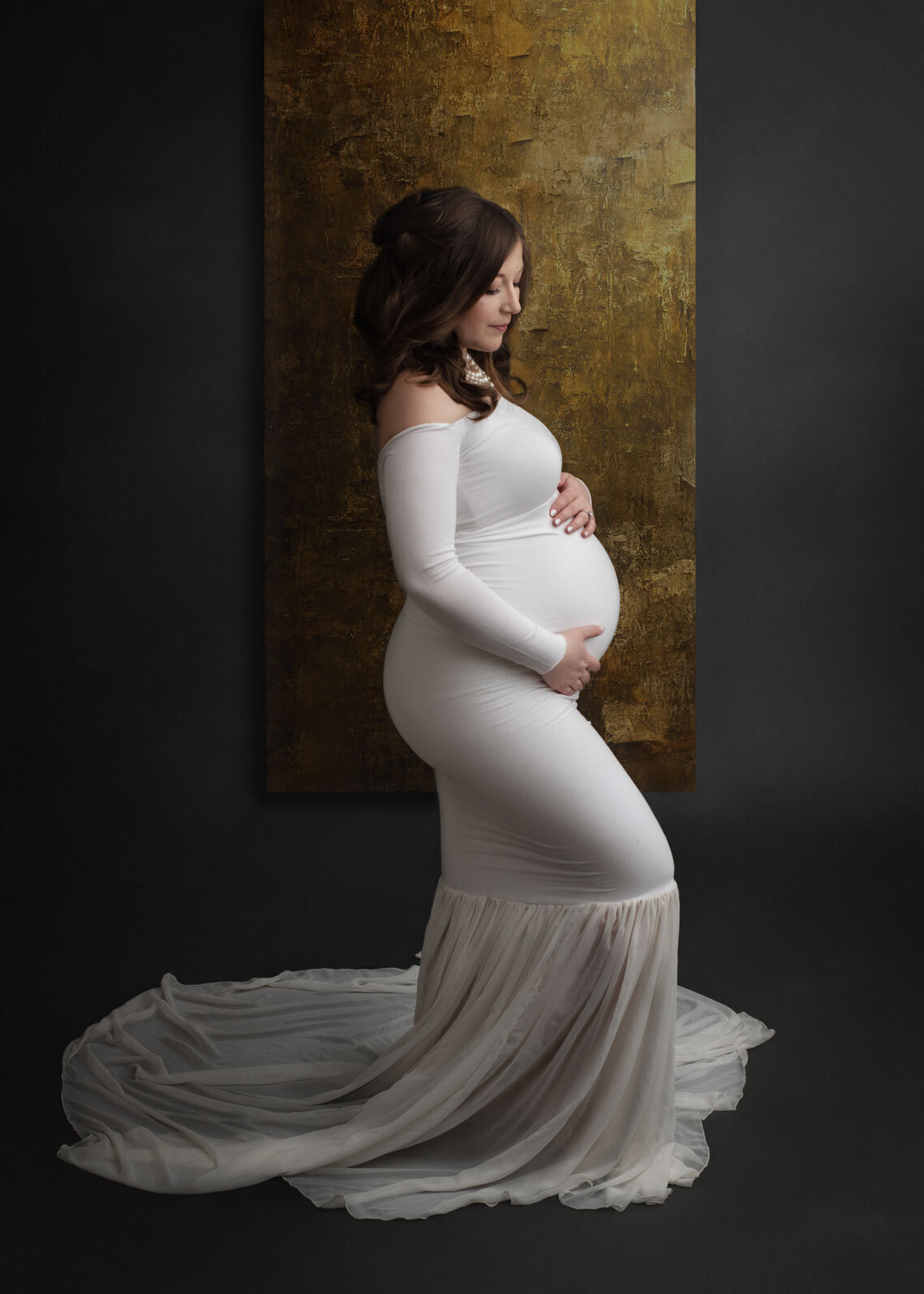 mom holding belly in white gown at st. louis maternity photo session