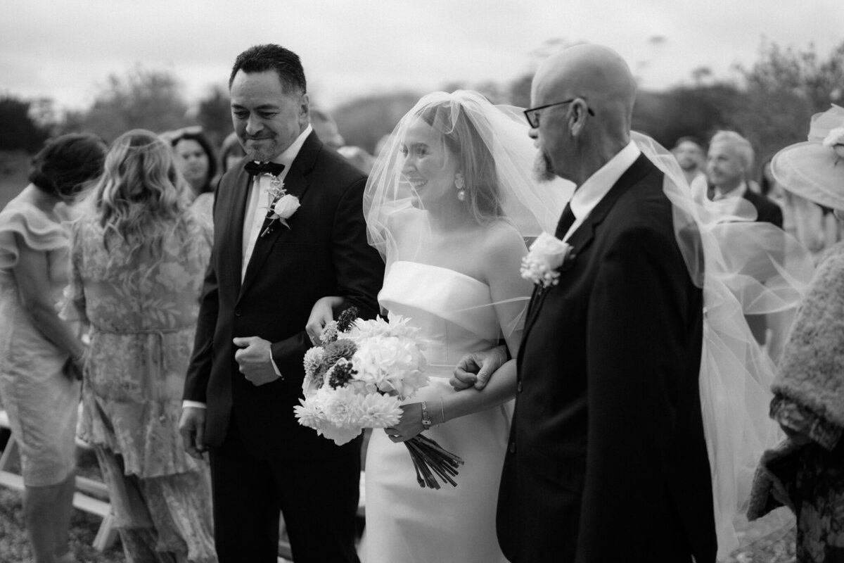 joyful photo of bride arriving at wedding ceremony in auckland 