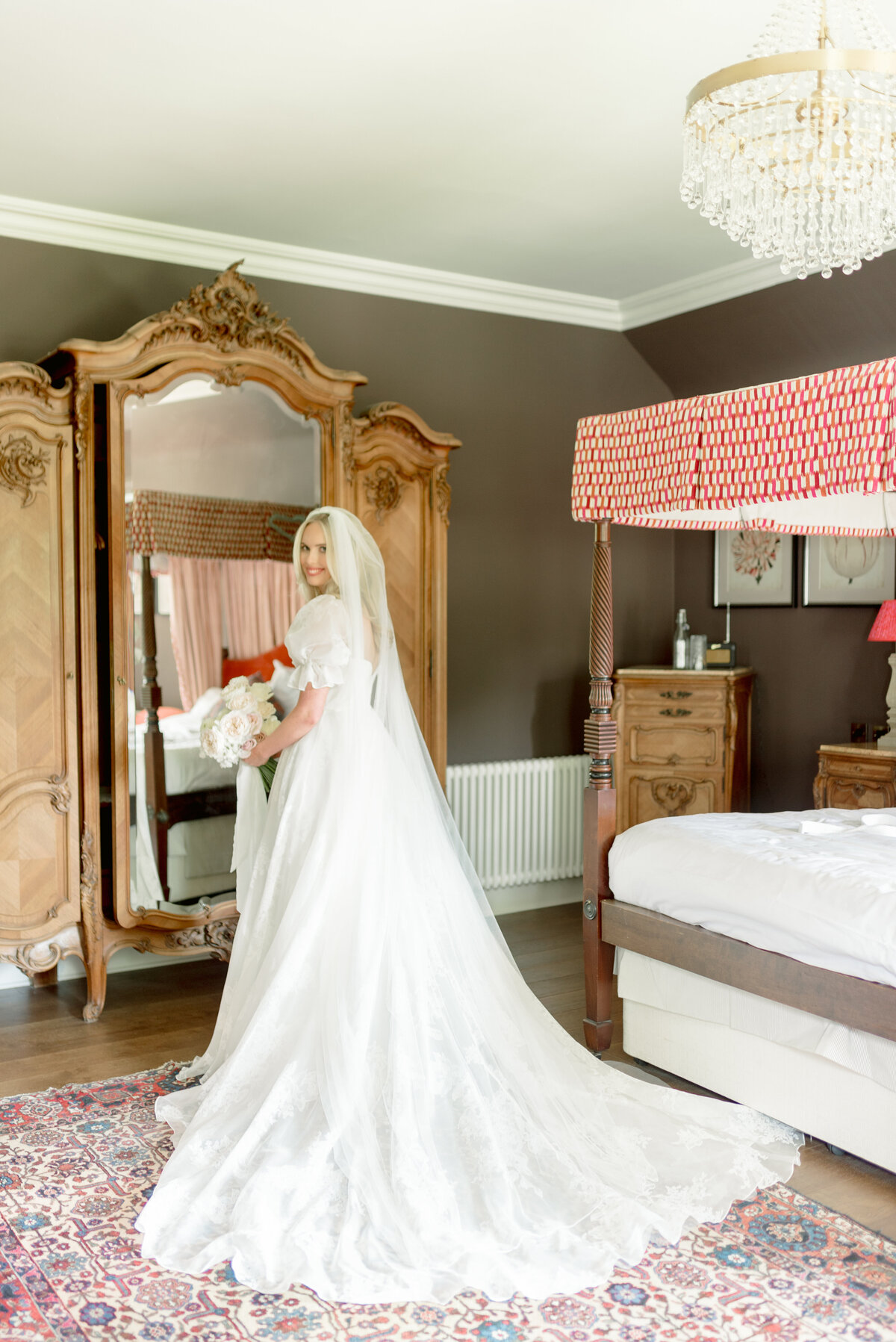Beautiful wedding morning portrait of Bride in patterned silk wedding dress with puff sleeve, cathedral length veil and peony rose bouquet with satin ribbons by Lavender and Rose Events in the Bridal Suite of Cromlix House, Scotland.