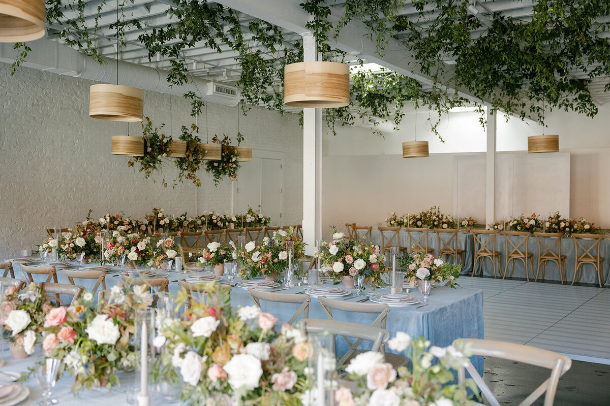 Fall wedding in Raleigh, NC highlights the beautiful autumnal setting in the Carolinas. Floral colors of copper, terra cotta, dusty pink, mauve, dusty blue, taupe, cream, and natural green. Flowers consisting of roses, dahlias, ranunculus, thistle, rain tree pods, and fall branches. Design by Rosemary and Finch Floral Design based in Nashville, TN.