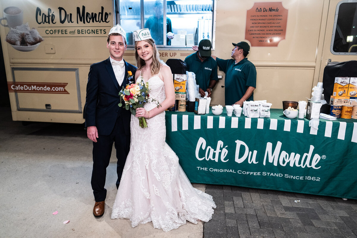 Bride and groom in front of Cafe du Monde food truck at Southern Oaks