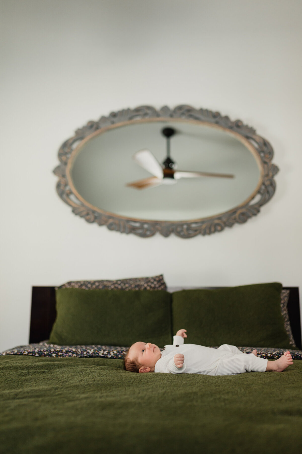 Newborn baby laying on a bed
