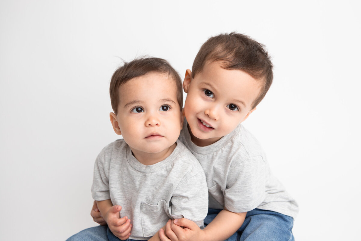 YEG Studio portrait of little boy brothers on a plain white backdrop savage seamless paper