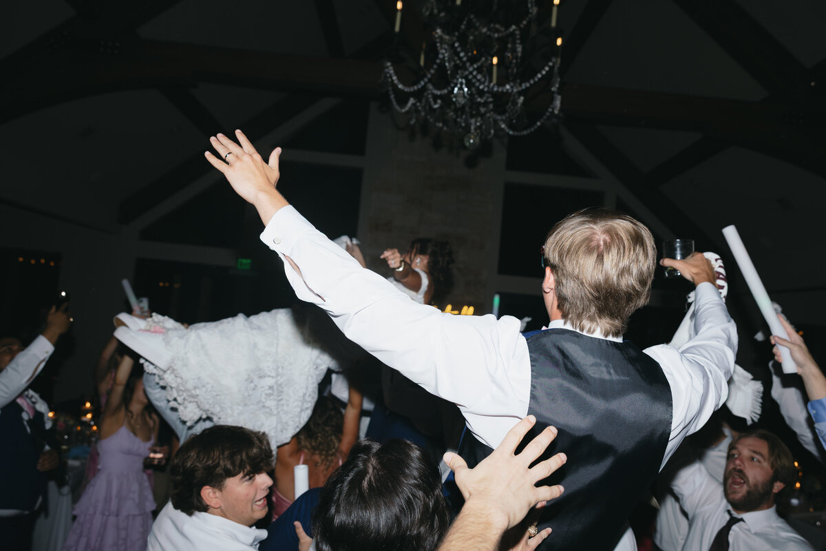 reception bride and groom lifted up