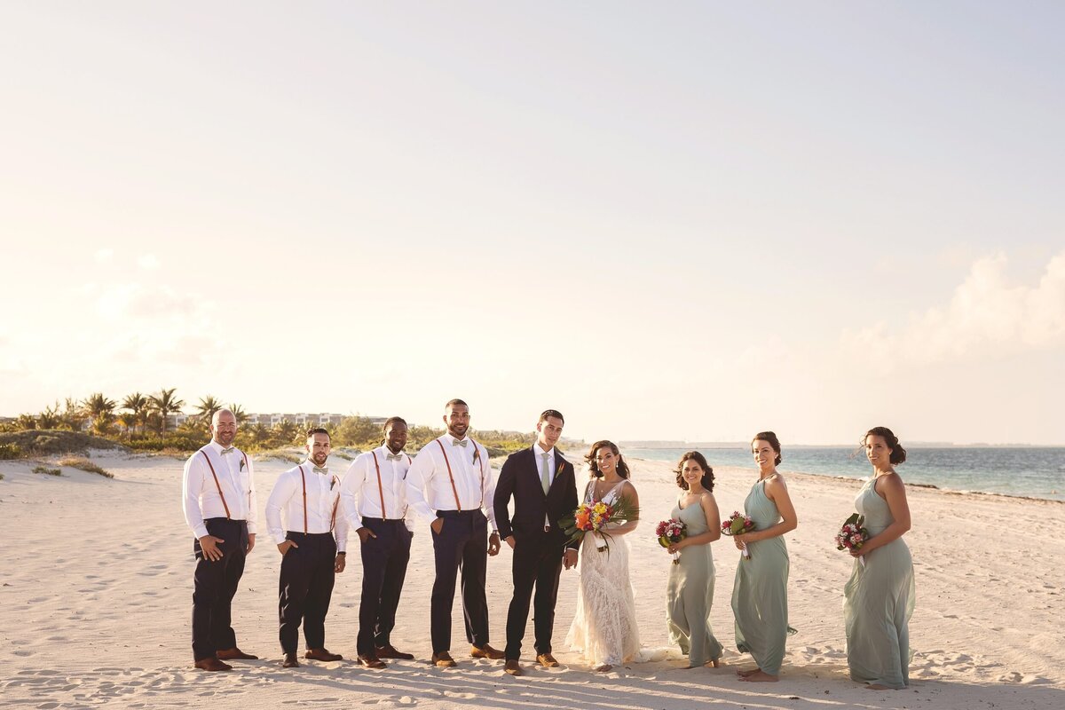 Portrait of bridal party on beach after wedding in Cancun