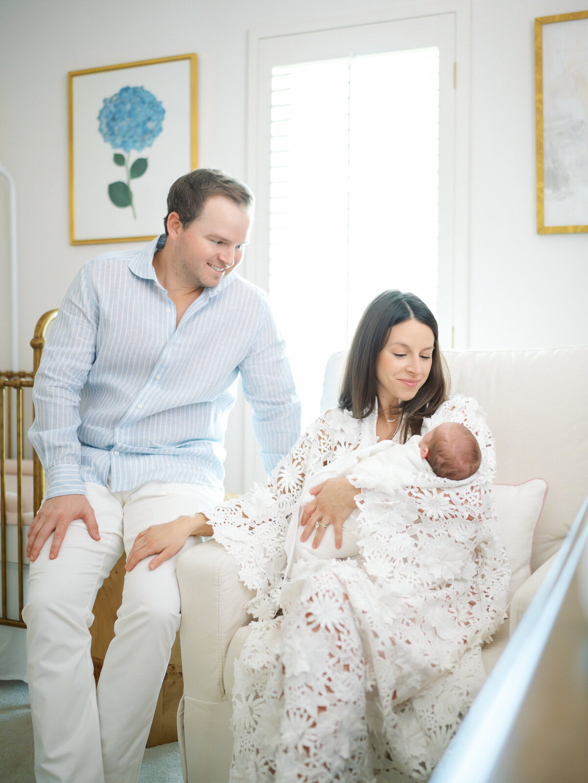Parents hold newborn who is smiling. DFW Luxury Family Photographer I Tate Smith Photography 