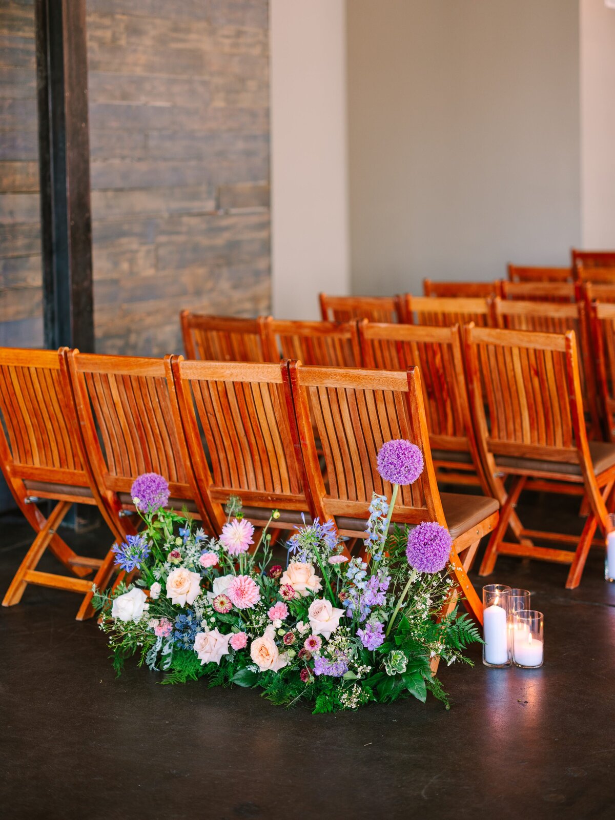 Spring colored floral arrangement at the start of a wedding ceremony.