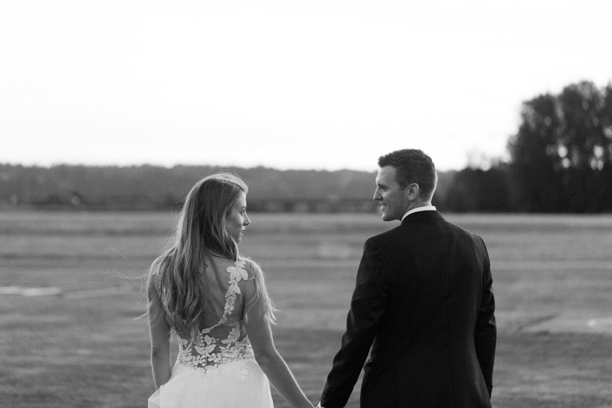 Dramatic-Black-and-white-photo-of-bride-and-groom-at-golden-hour-at-Snohomish-Airport-photo-by-Joanna-Monger-Photography