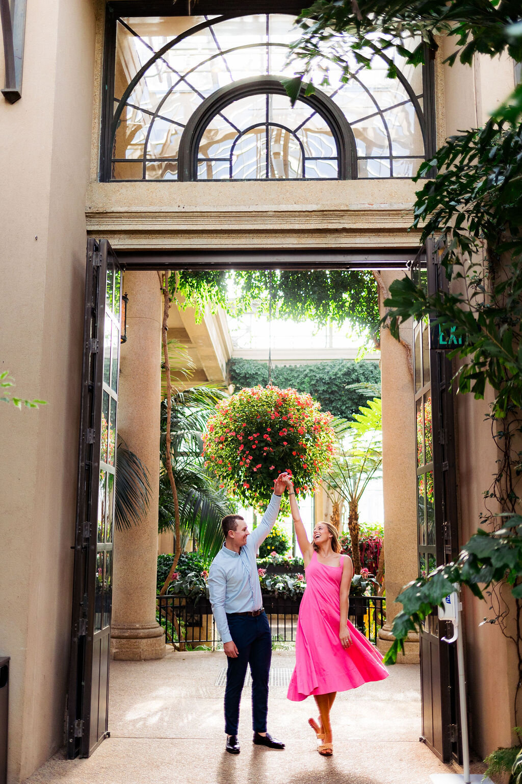 Two people dancing in the doorway of a garden