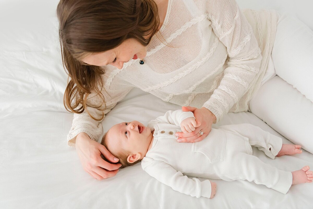 mom looking at baby taken by family photographer boston ma​