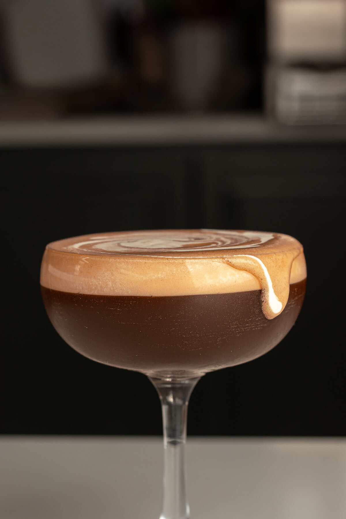 a cocktail drink with coffee in it in a glass