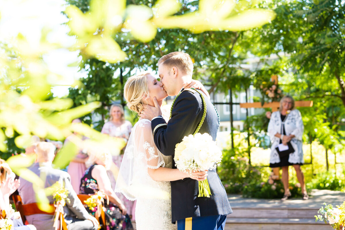 Bride and groom kissing at wedding ceremony at Fat Bottom Brewery, Nashville, TN