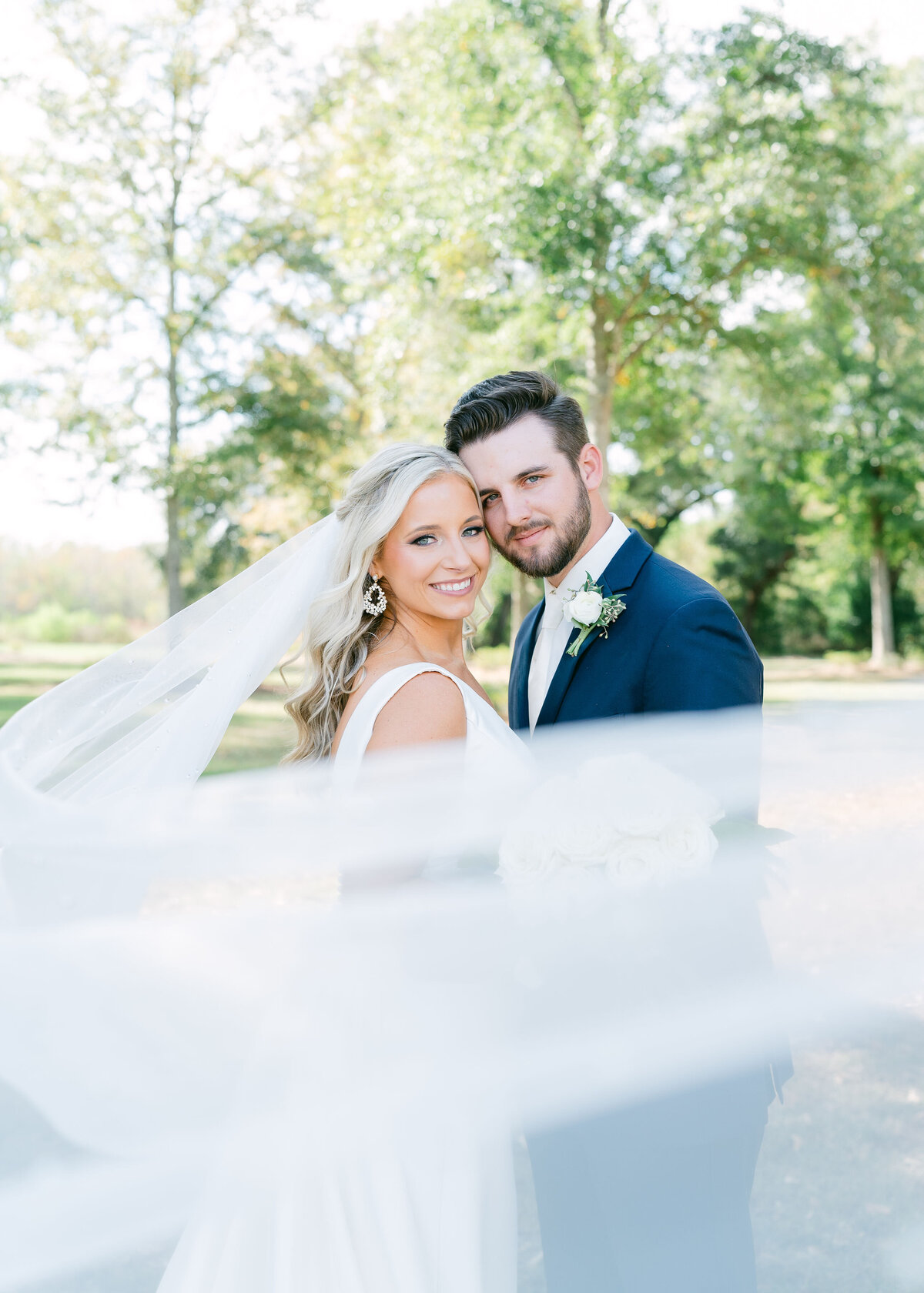 bride and groom veil portrait