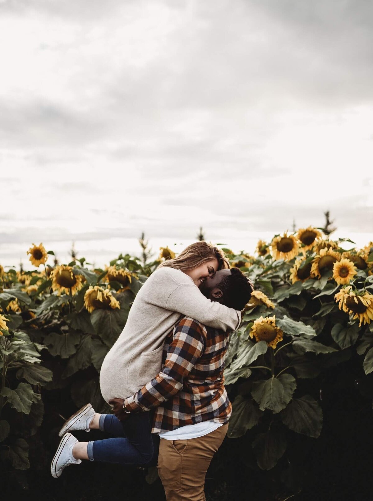 couple in edmonton sunflower field hugging