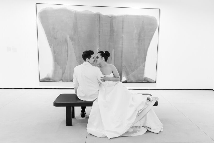 bride-and-groom-sitting-by-art-at-museum-of-contemporary-arts-san-diego-wedding