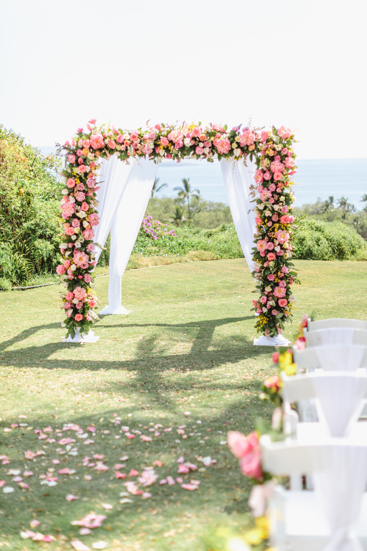 Maui Weddign PlannerWedding arch adorned with full coverage peonies and roses at Gather Here on Maui, with stunning views of Molokini Island.