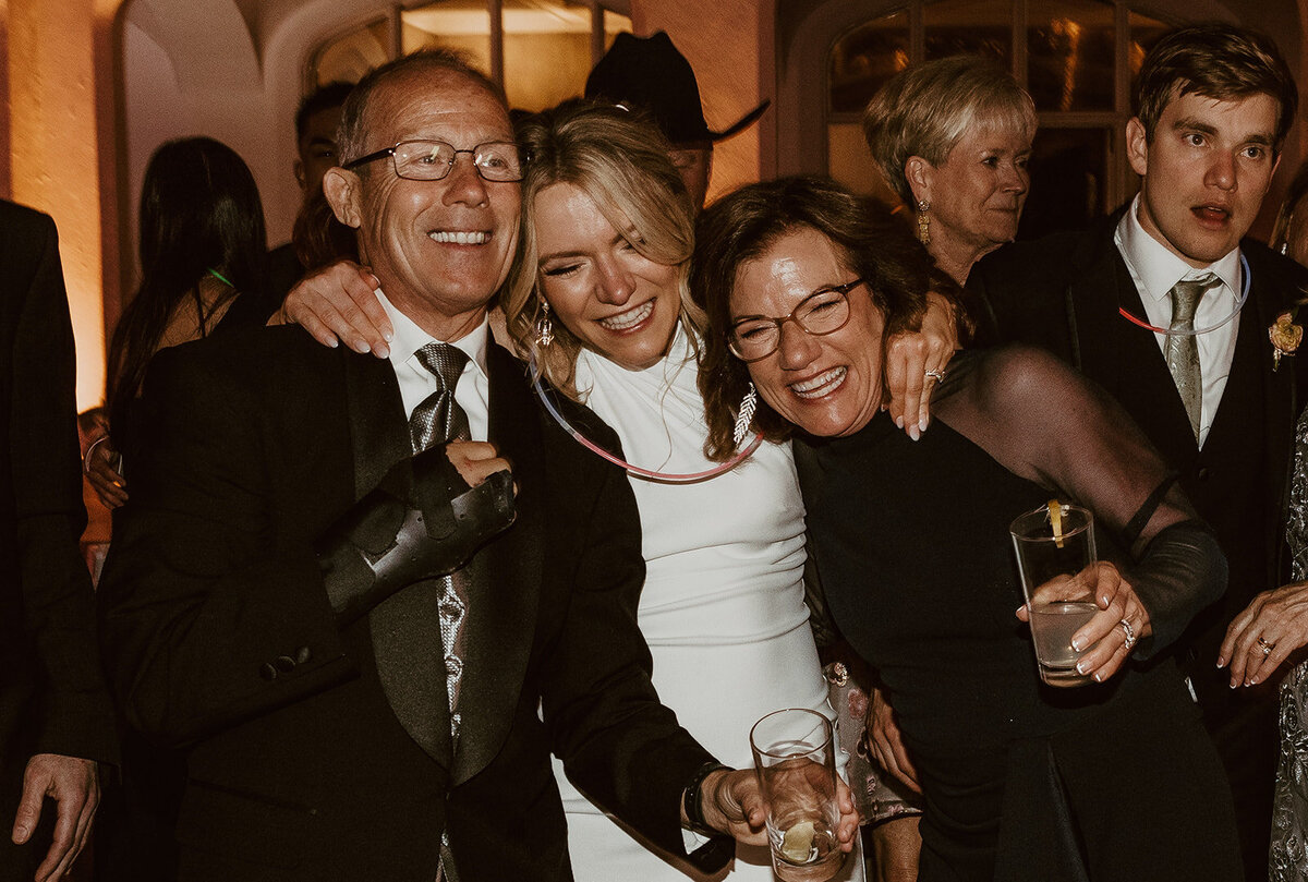 bride pulls her parents in tightly during last dance 