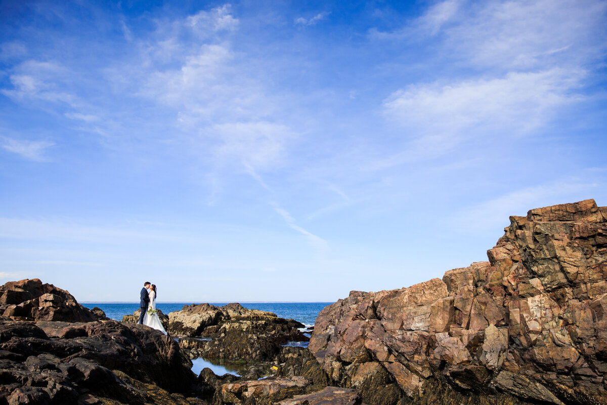 Couple stands in front of the ocean after their Maine elopement