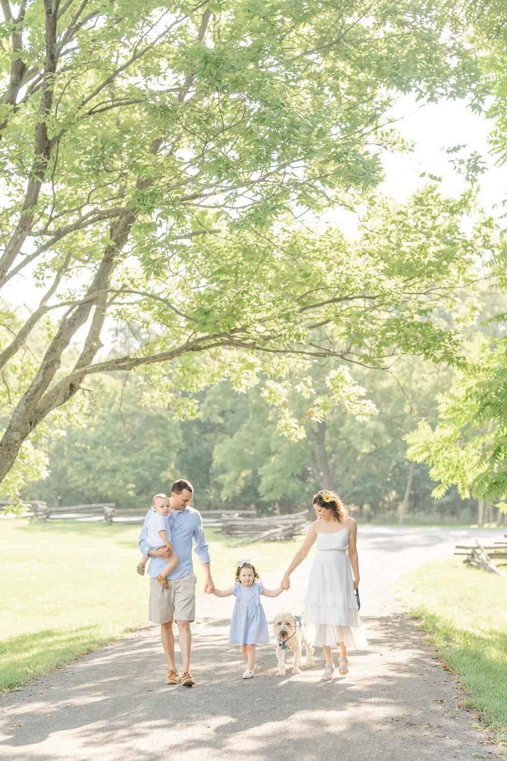 parents and kids walk with their dog taken by Northern VA family photographer