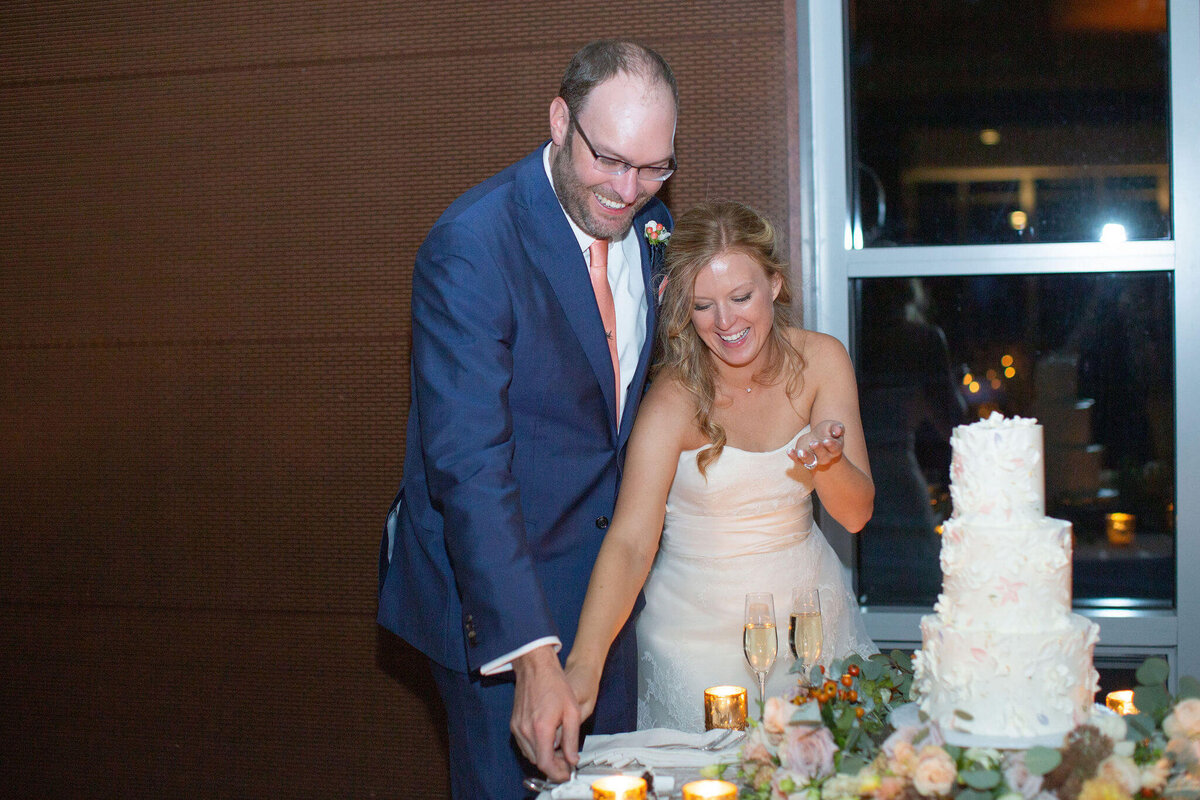 bride and groom cut their cake