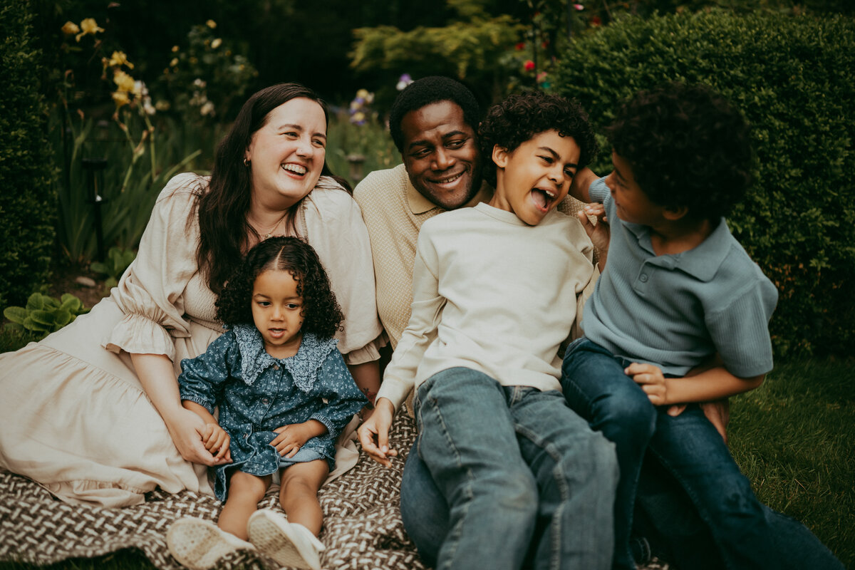 child at the beach in Portland, Oregon with her parents, laughing