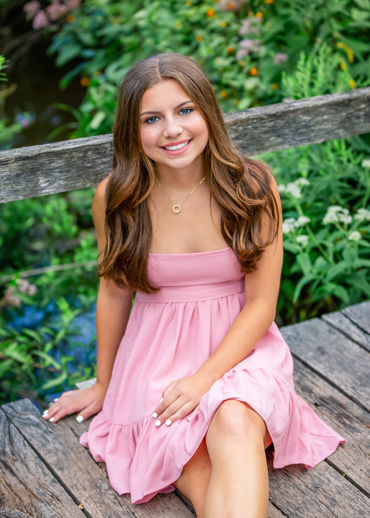 Pretty Senior pictures taken of a girl wearing a pink dress from Victor, NY