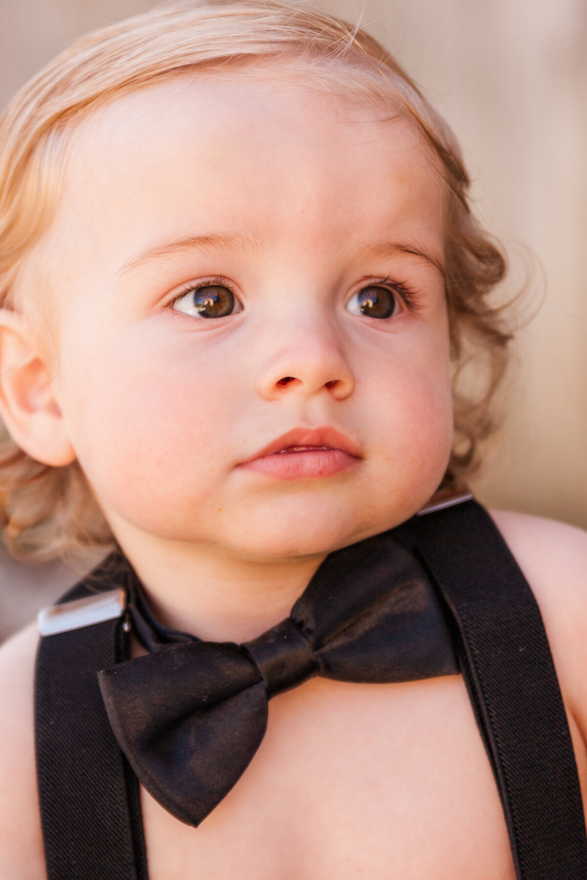 baby wears a black bow tie