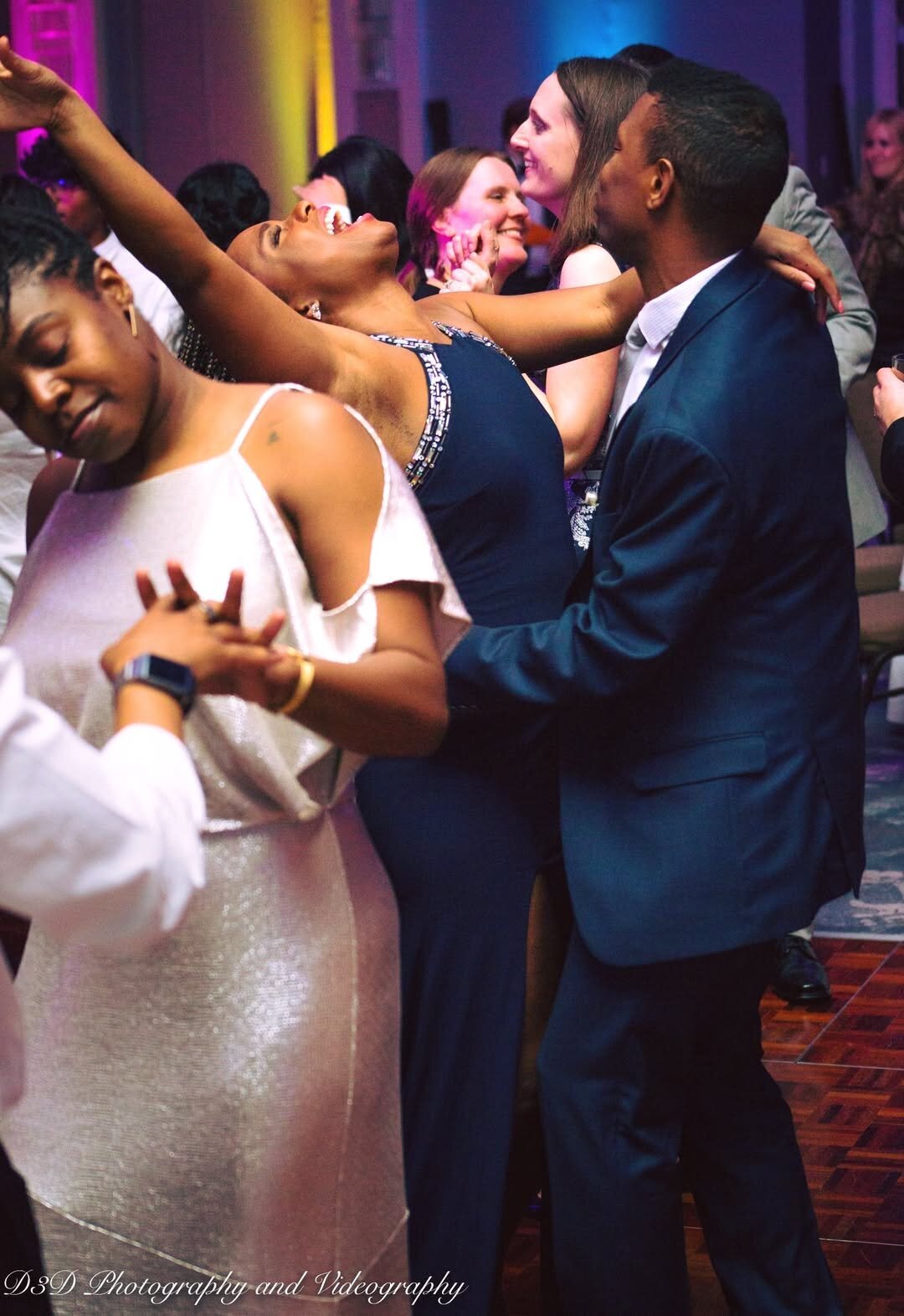 Corporate party dance floor photography by D3D Photography capturing joyful celebration moments with colorful lighting