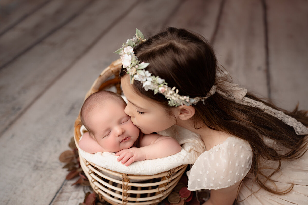 Brighton Newborn Photography Baby kissed by sister By For The Love Of Photography