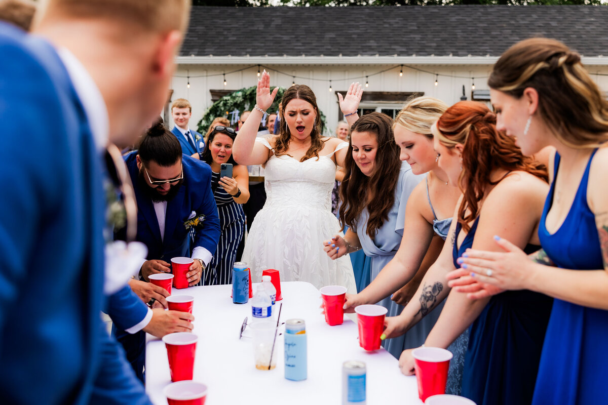 A wedding party plays flippy cup.