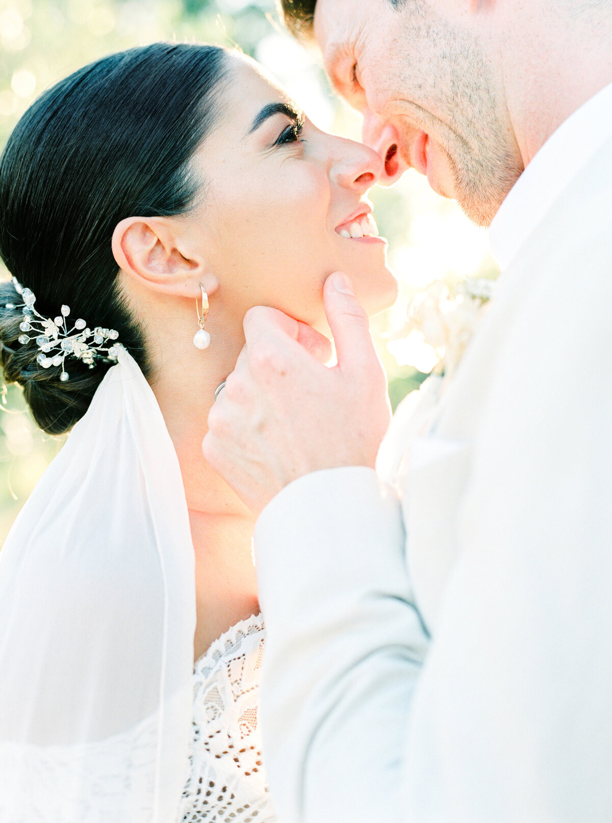 Film photograph of close up of bride and groom smiling and almost kissing photographed by Italy wedding photographer at Villa Montanare Tuscany wedding
