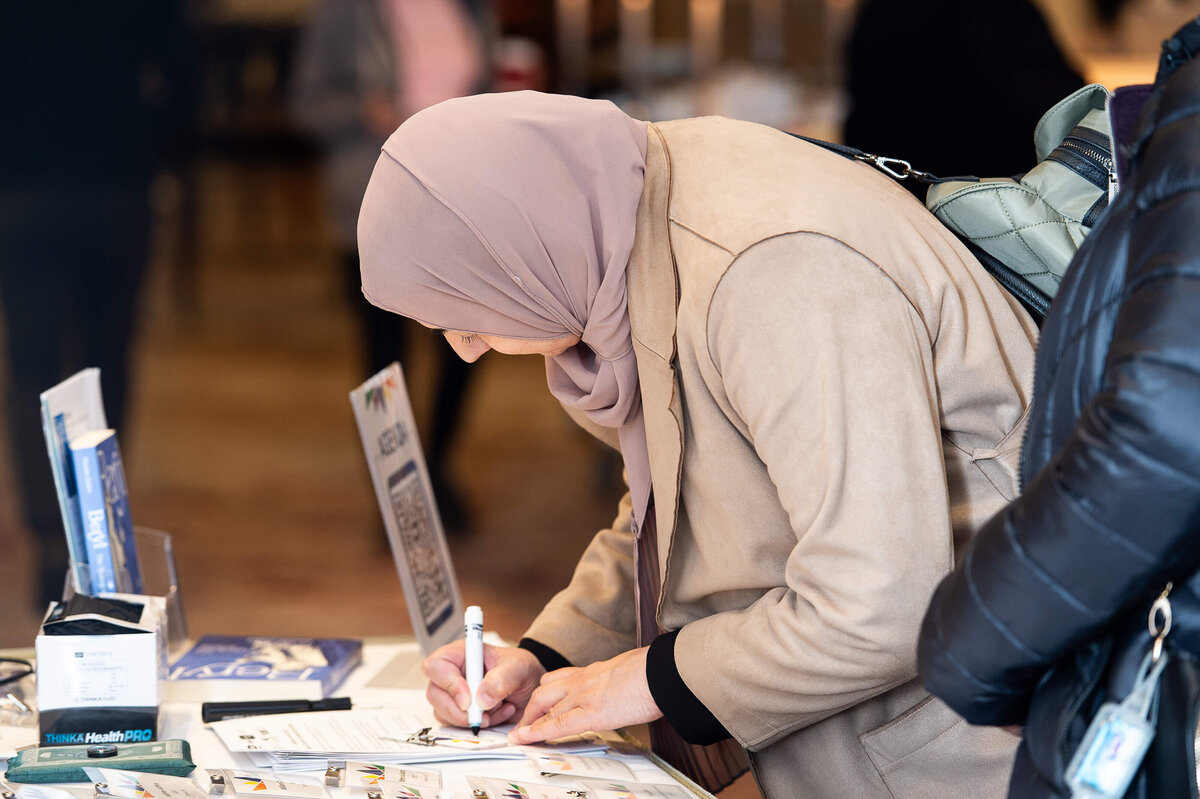 Ottawa event photography showing an attendee registering during a 2-day conference. Captured by JEMMAN Photography COMMERCIAL