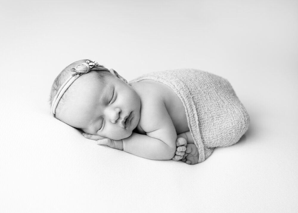 high-key-black-and-white-newborn-girl-with-white-wrap