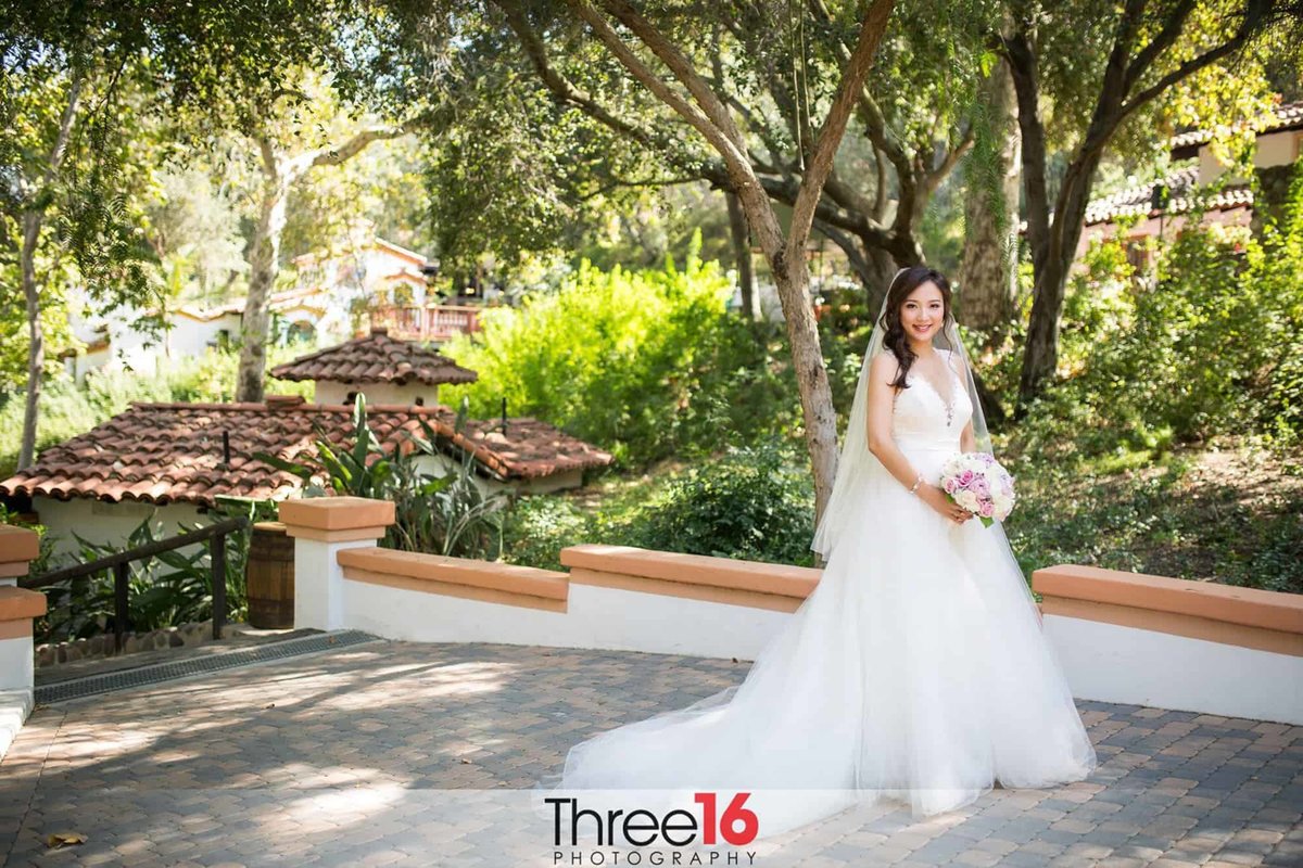 Pretty Bride poses with her gown train fanned out
