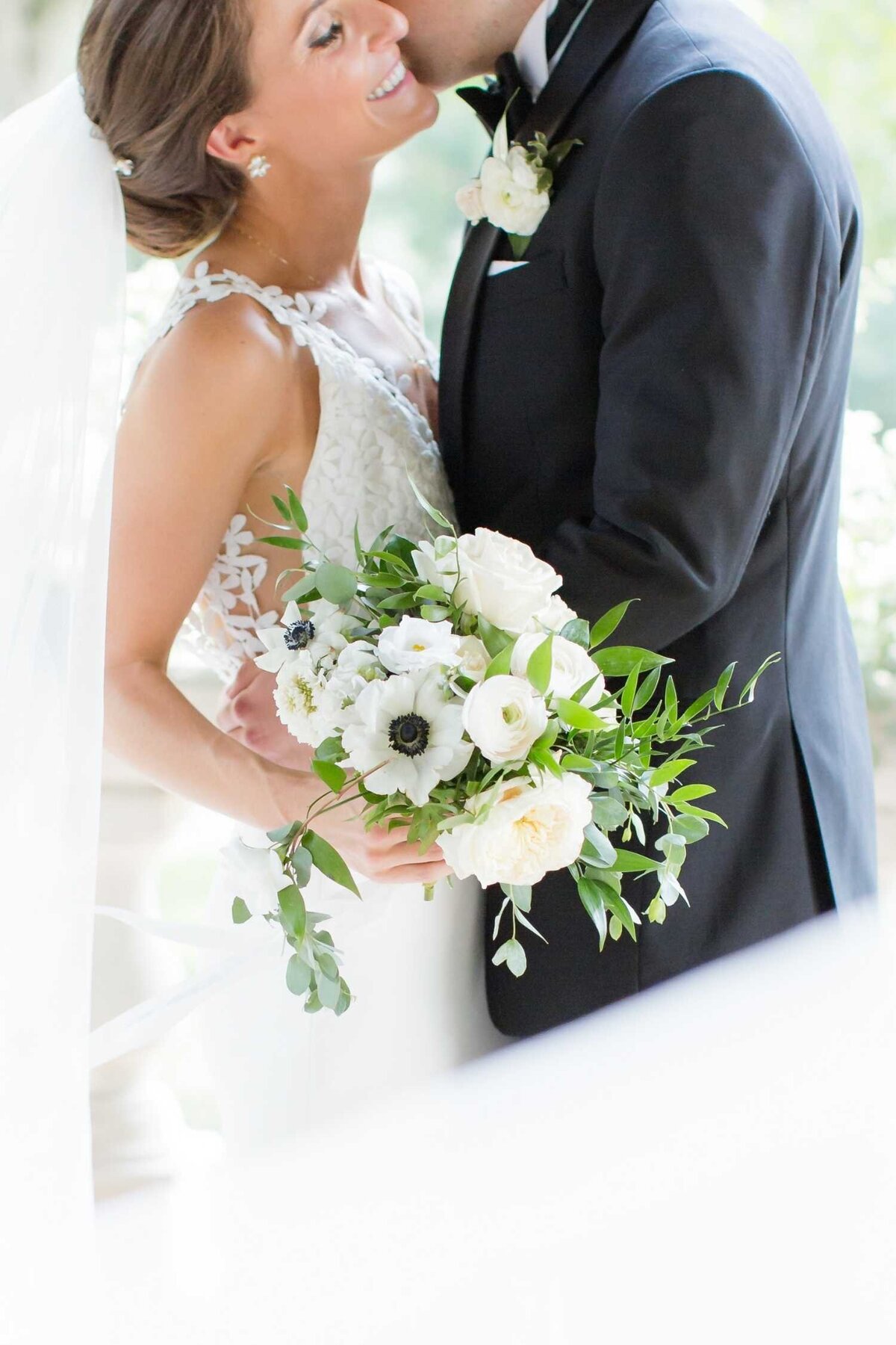 Bride and groom photo with bride's lush garden style bouquet with white and green flowers for a Luxury Chicago Outdoor Historic Wedding Venue.