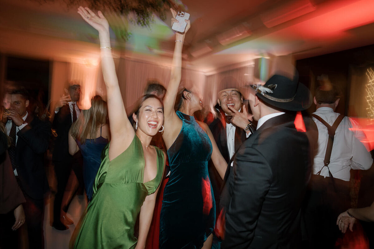 A colorful image depicting the joy and fun being had by guests at an Aspen Meadows Resort wedding reception.