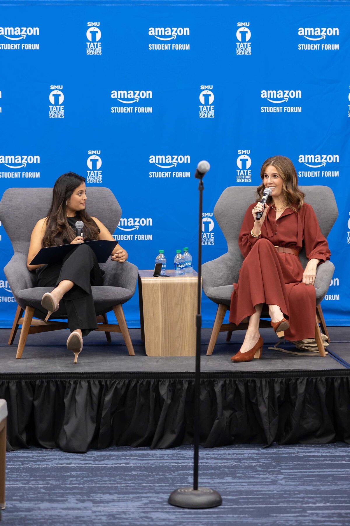 Branding events photography by Sophie K. Hunter capturing two powerful women debating during a business event in Dallas, TX.