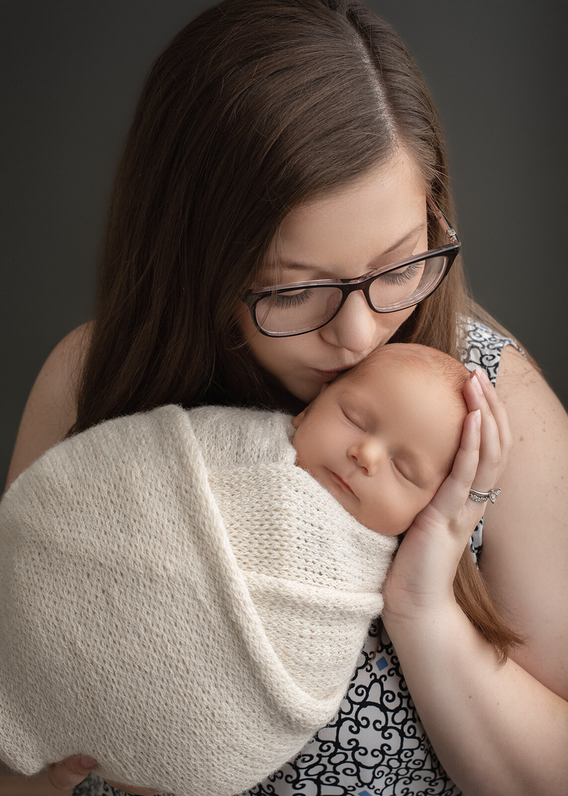 mom kissing baby at St. Louis newborn photo session
