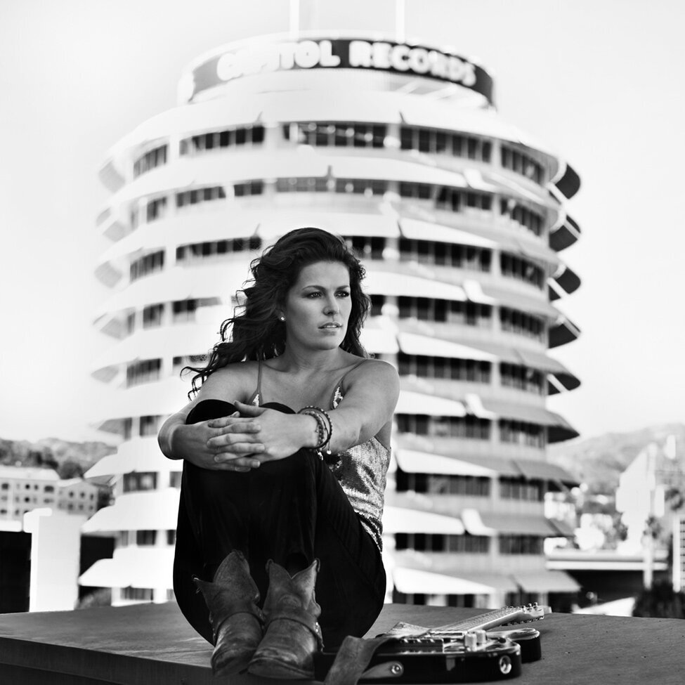 Female Guitarist portrait Los Angeles Hayley sitting on rooftop electric guitar lying next to her Capitol Records building in background behind her Just Play Something Gallery